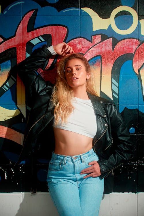 Young Woman Posing against a Graffiti Wall 