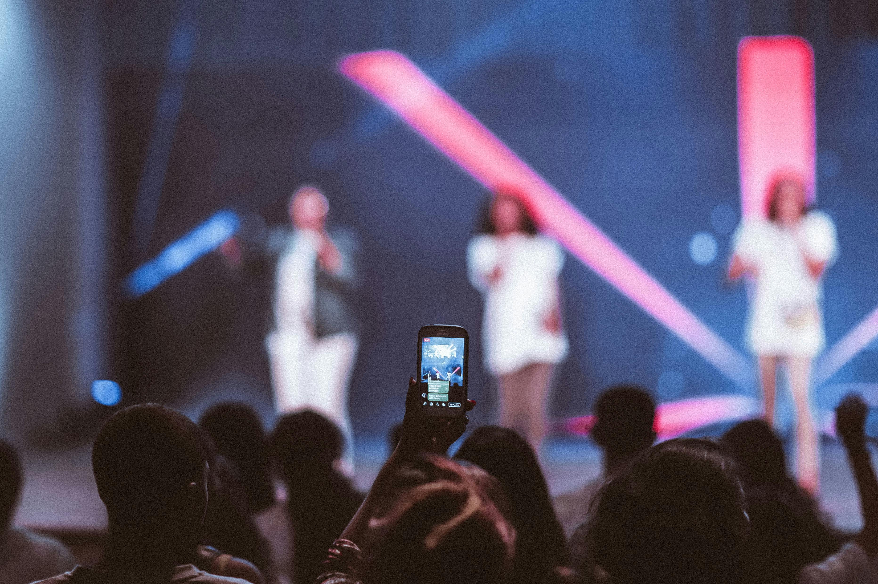 shallow focus of smartphone videoing concert