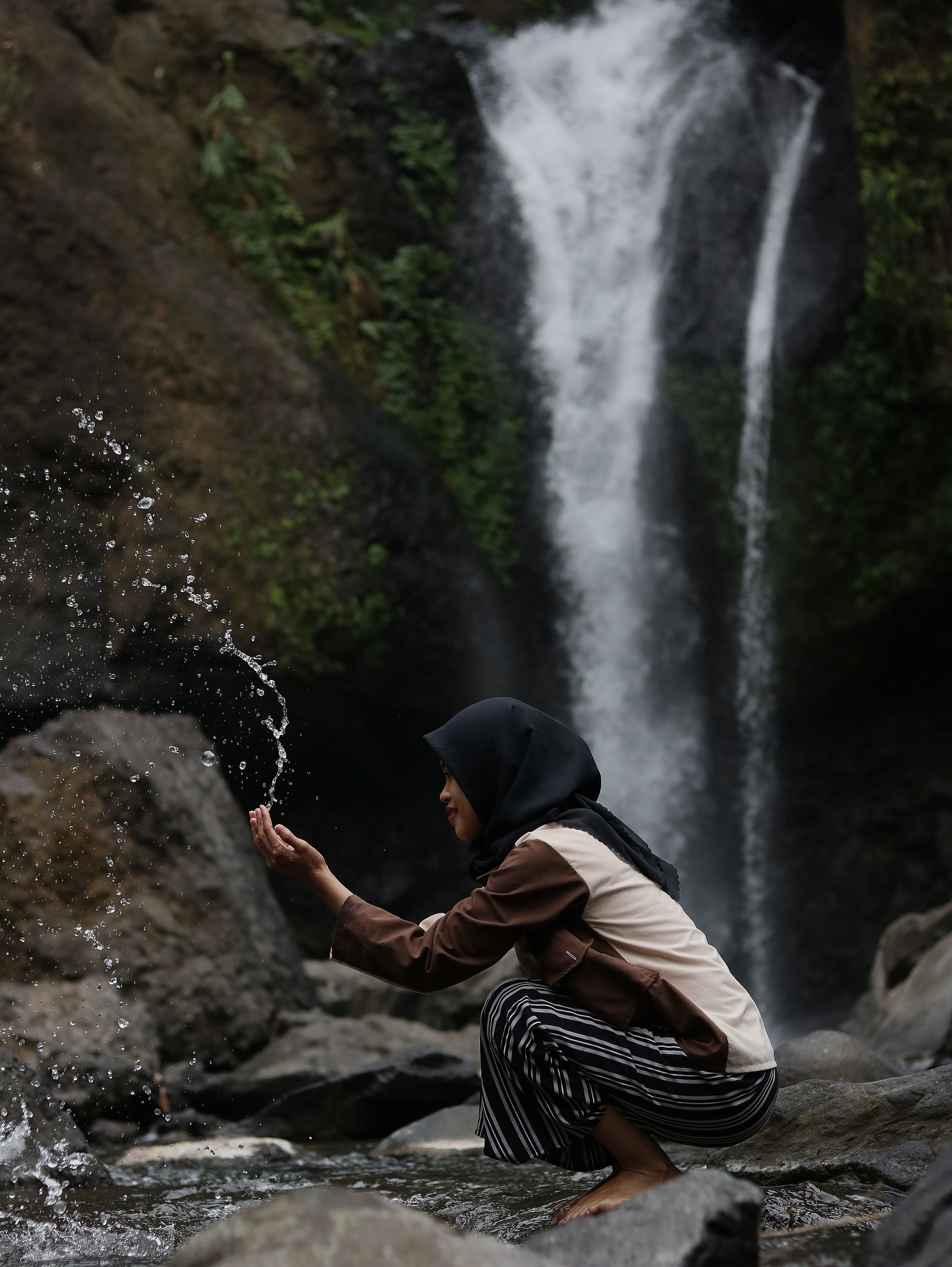 Young Woman in front of a a Waterfall