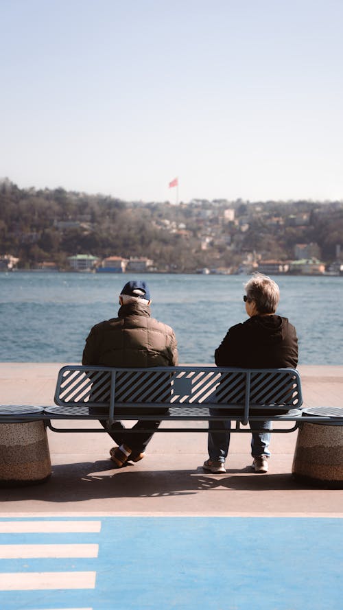 An Elderly Couple Sitting on a Bench