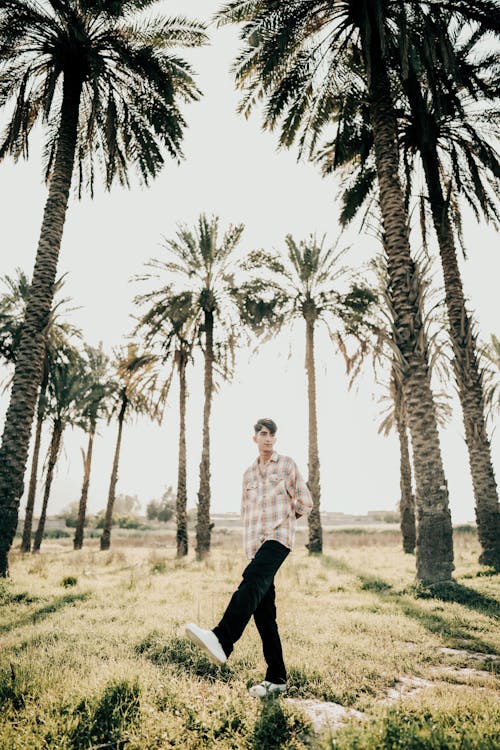 Man Posing Among Palms 