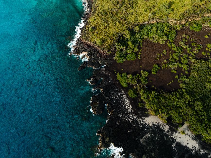Spectacular Complete Island 60-Minute Helicopter Tour Review: The Ultimate Maui Experience Review 2026 - Stunning aerial view of the diverse coastline in Honaunau-Napoopoo, Hawaii, with vibrant ocean and lush greenery.
