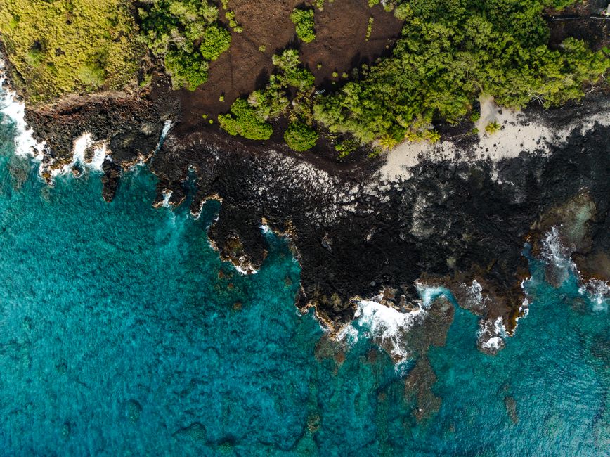 Amazing Big Island: Discover Hilo Helicopter Tour Review Review 2026 - Stunning aerial view of Honaunau-Napoopoo, Hawaii coastline with lush greenery and turquoise waters.