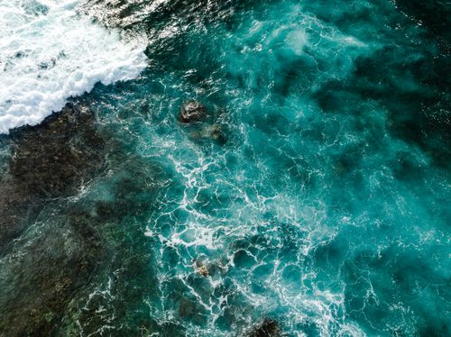 Free Breathtaking aerial shot capturing turquoise ocean waves splashing in Honaunau-Napoopoo, Hawaii. Stock Photo