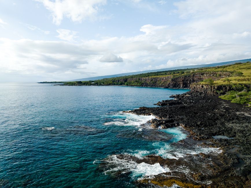 Incredible Big Island Spectacular Helicopter Tour Review: The Ultimate 2-Hour Volcanic Adventure Review 2026 - Breathtaking view of Honaunau-Napoopoo's cliffs and turquoise ocean waves along the Hawaiian coast.