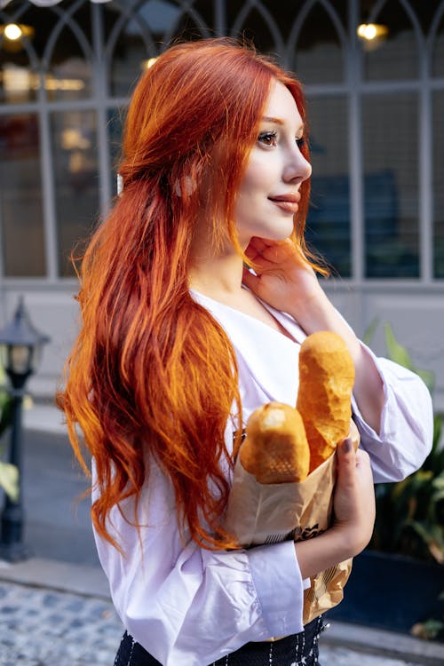 Free Redhead Woman Standing with Bread Stock Photo