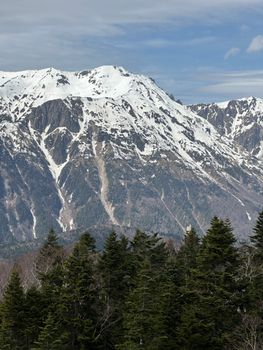 Explore the stunning snow-covered mountains in Takayama, captured on a clear day. Perfect for nature lovers.