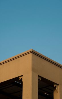 A minimalist architectural structure with a clear blue sky background. Perfect for modern design aesthetics.