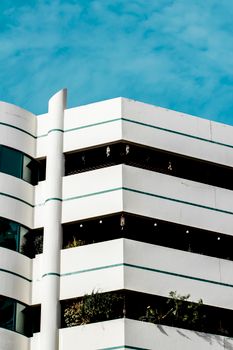 Striking view of a modern white building facade under a clear blue sky.