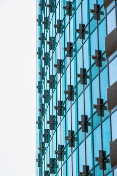 A contemporary skyscraper with blue glass windows, capturing urban architecture.
