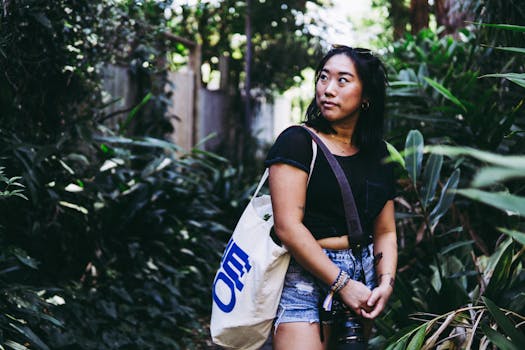 Candid portrait of a young woman exploring a lush garden with a camera.