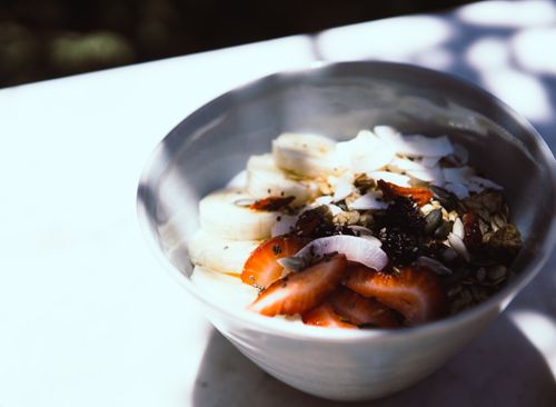 Free A refreshing bowl of sliced fruits, coconut flakes, and seeds for a nutritious start. Stock Photo