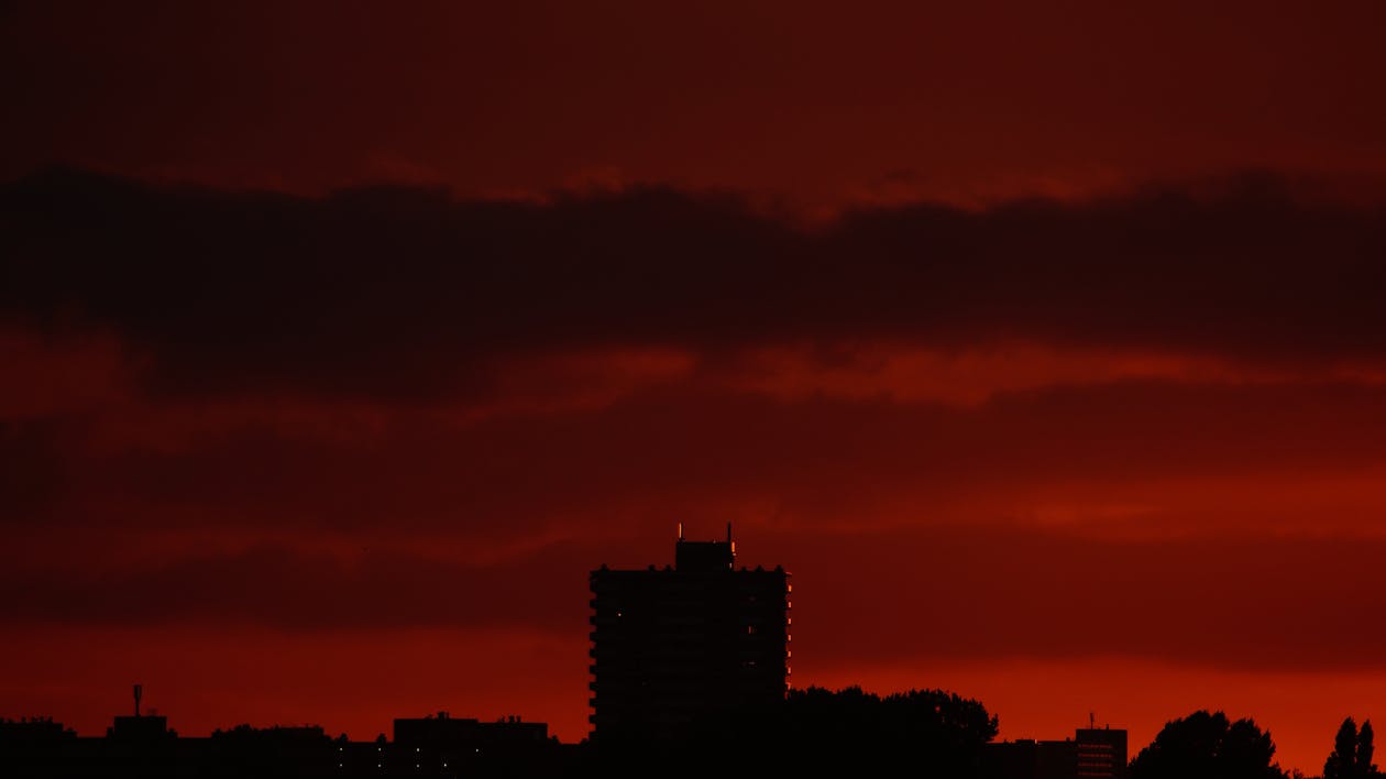 Silhouette of Building Structures Against Red Skies