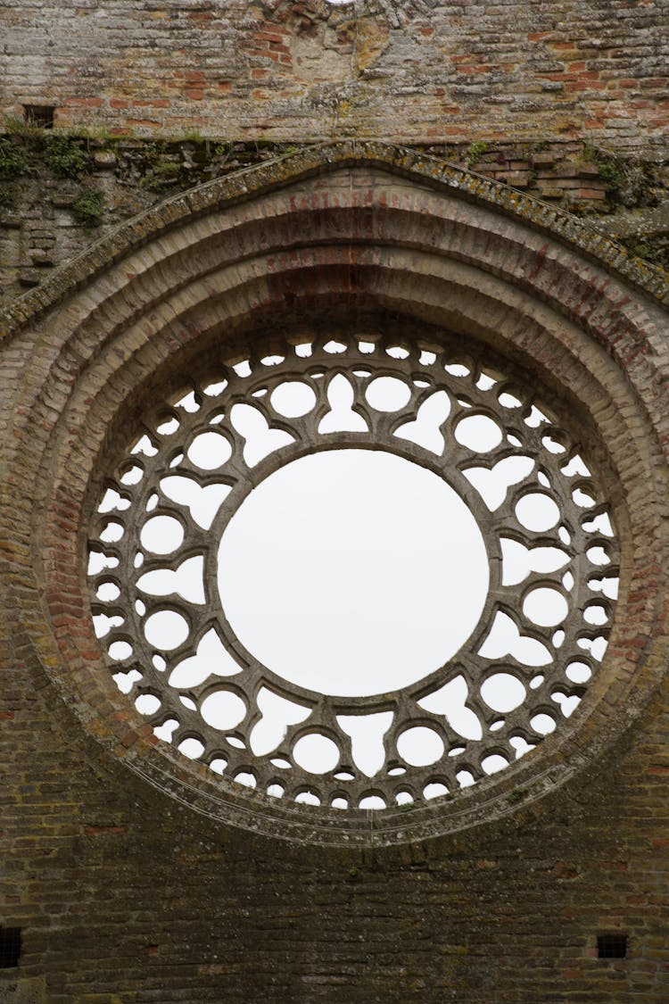 A Circular Window In A Brick Wall