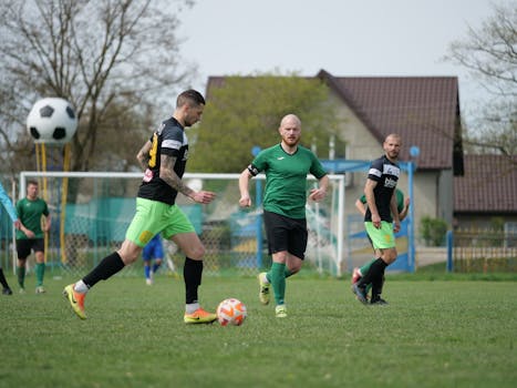 Intense soccer match with players in motion on a vibrant green field. Perfect sports action shot.