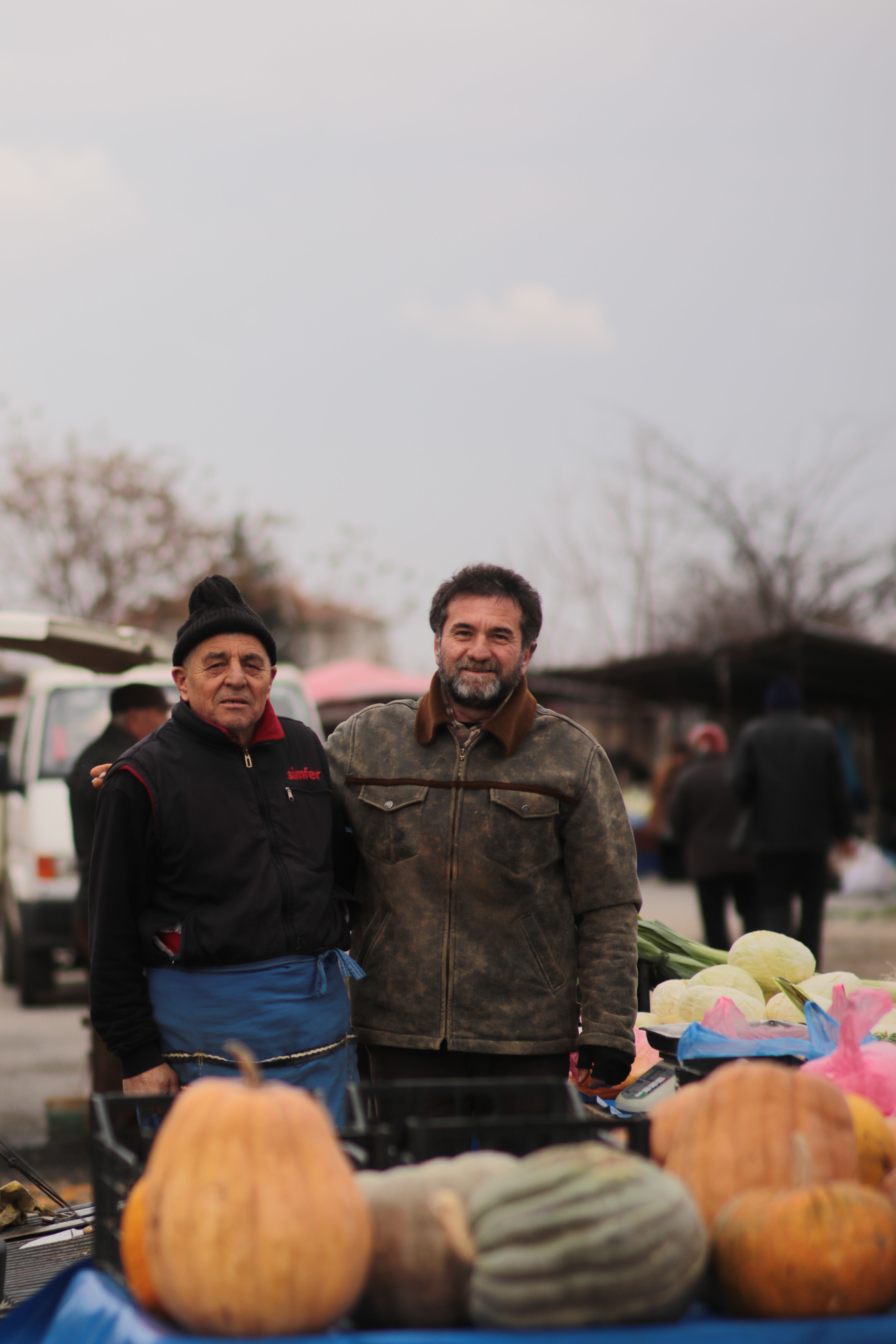 Merchants at Stall with Pumpkins · Free Stock Photo