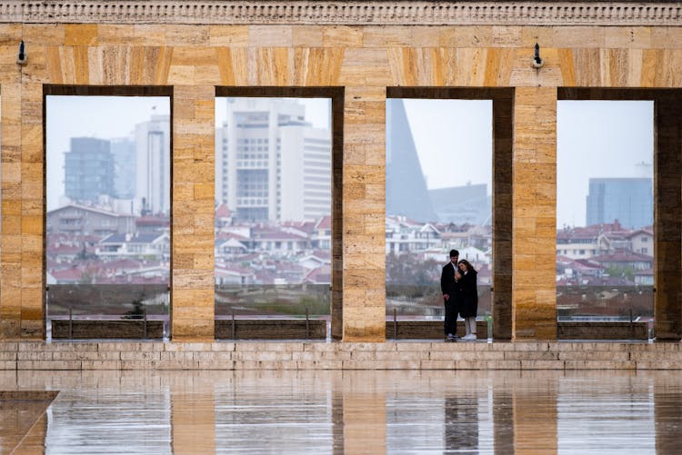 Couple Hiding From The Rain Under The Colonnade Of Mustafa Kemal Ataturk Mausoleum