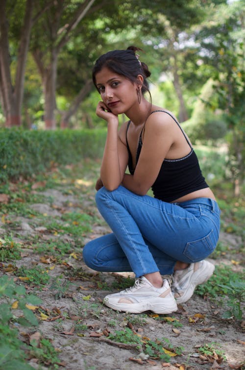 Woman Kneels o Rural Path