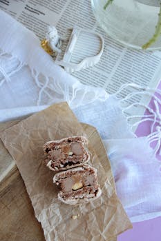 Delicious chocolate cookies presented on a rustic paper setup with cozy elements.
