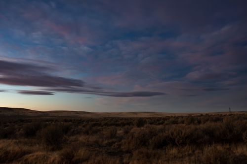 Free Peaceful twilight view of vast grassland under a scenic sky. Stock Photo