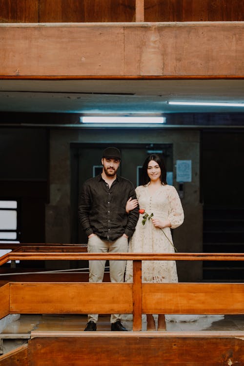 Young Couple Standing in a Building and Smiling 