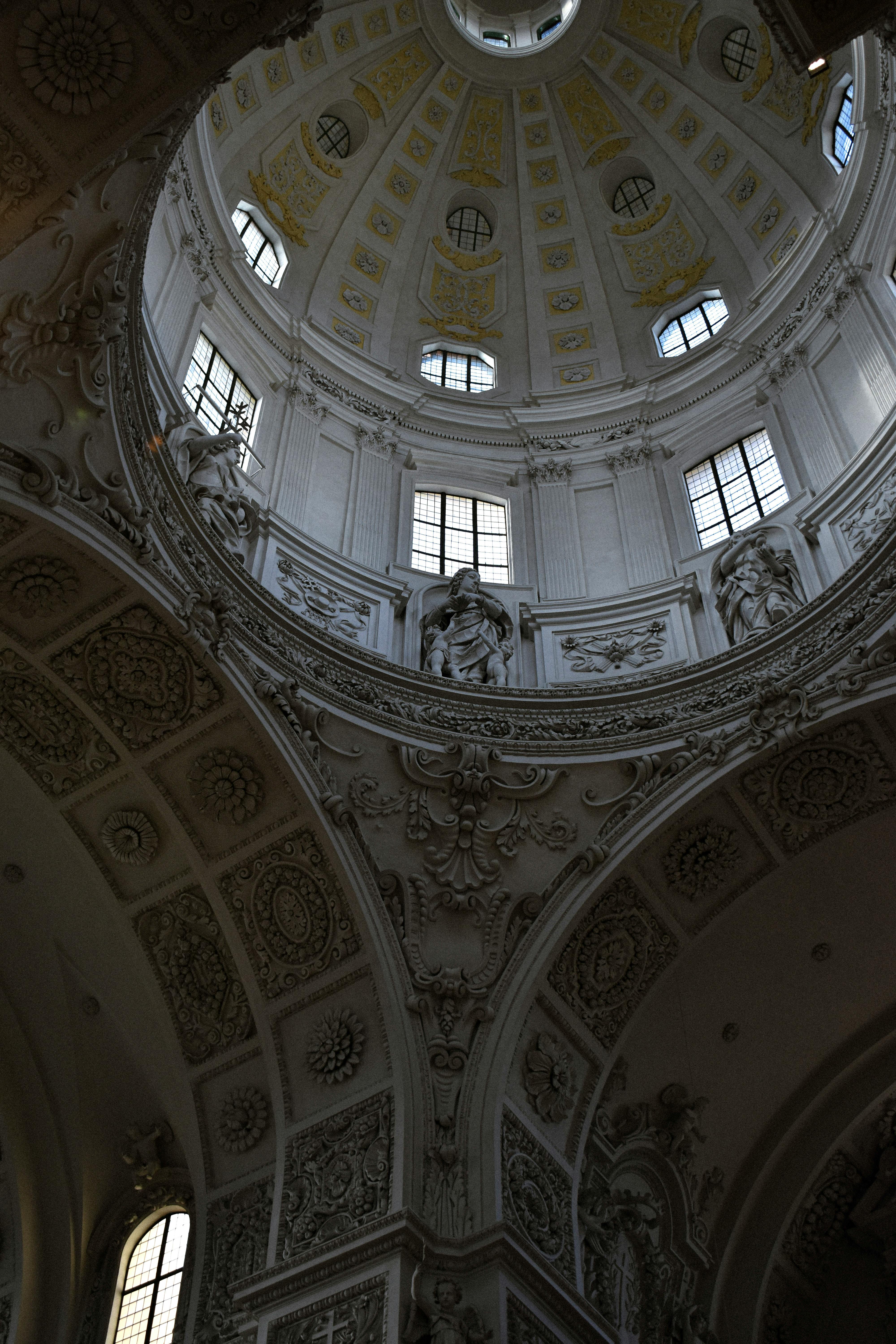 Intricate interior view of a church dome, showcasing reliefs and ornamentation.
