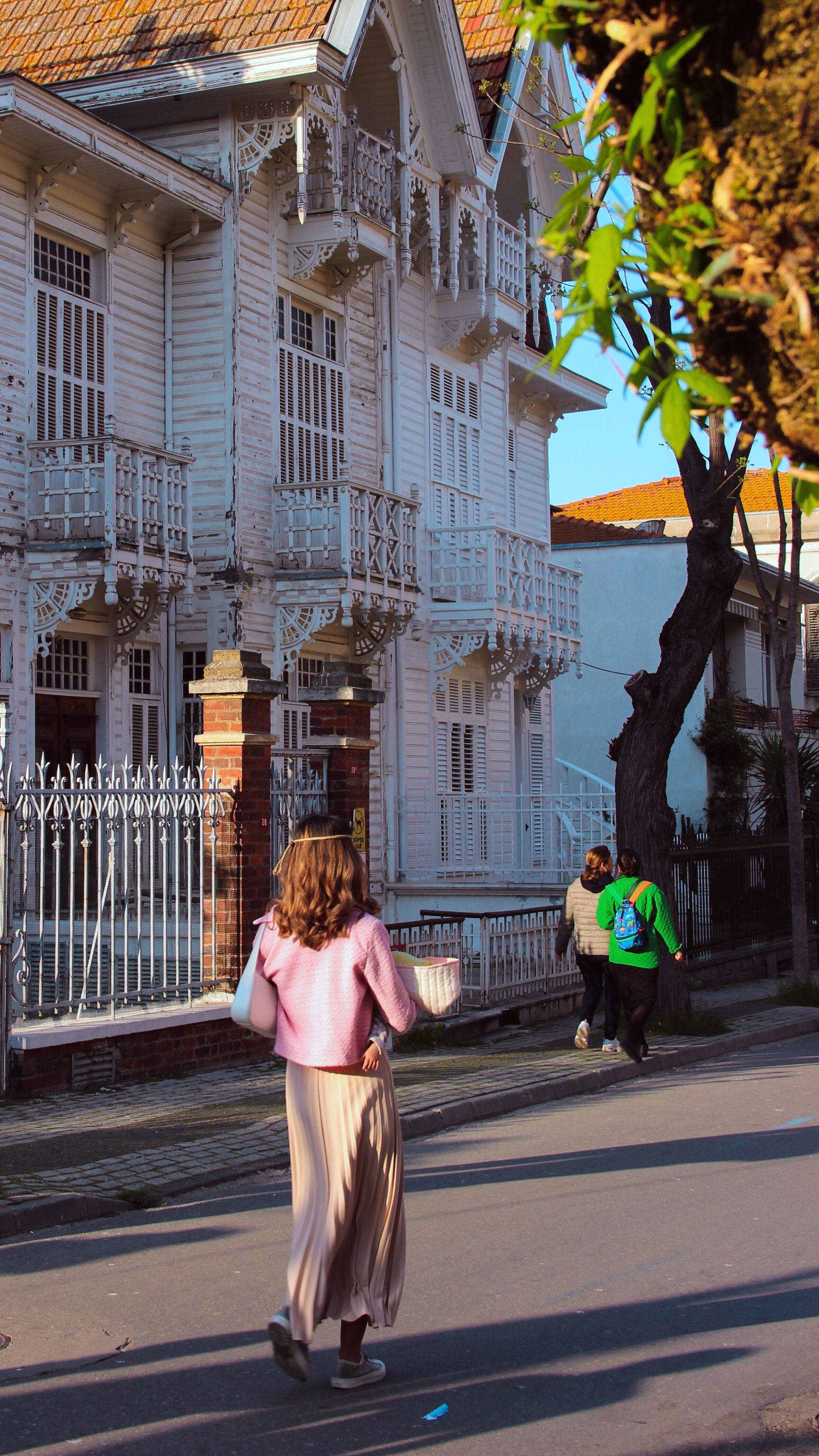 Street view of pedestrians walking past traditional architecture in Adalar, İstanbul.
