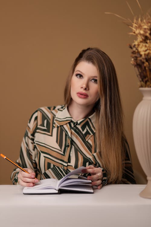 Woman Sitting with Notebook