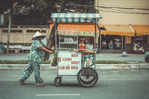 Person Pushing Food Cart On Road