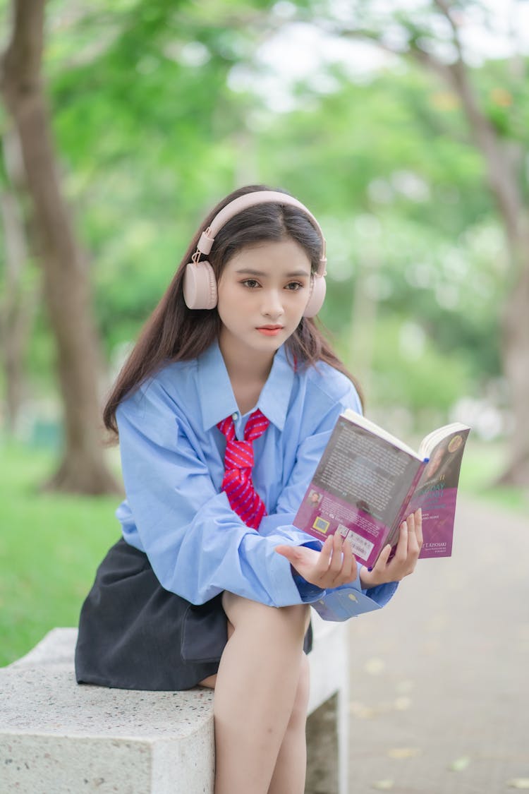 Woman In Shirt Sitting With Book In Park