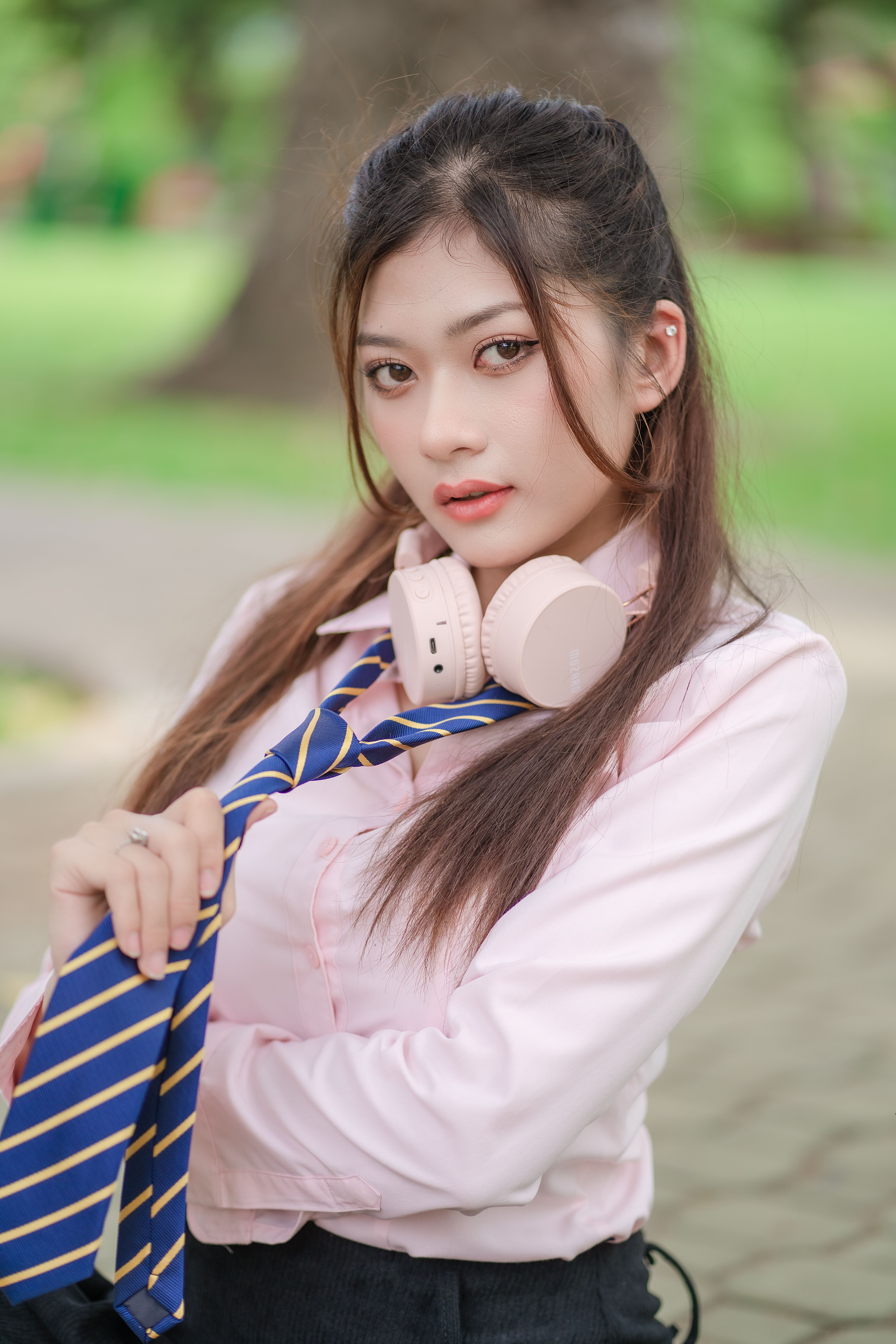 Young Woman in a School Uniform Standing Outdoors · Free Stock Photo
