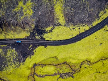 Aerial Photography of Blue Vehicle at Road