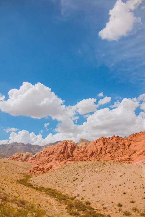 Free Scenic view of Red Rock Canyon with clear blue sky and white clouds, highlighting the vibrant desert landscape. Stock Photo