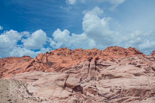 Free Stunning Red Rock Canyon with vibrant red sandstone rock formations under a bright blue sky. Stock Photo