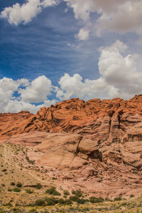 Free Scenic view of Red Rock Canyon's stunning formations under a bright blue sky with clouds. Stock Photo