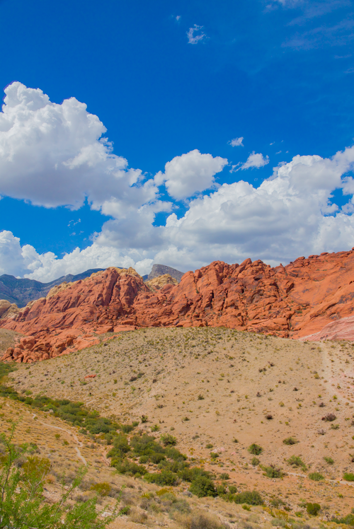 Free Red Rock Canyon's majestic formations beneath a vibrant blue sky in Nevada. Stock Photo