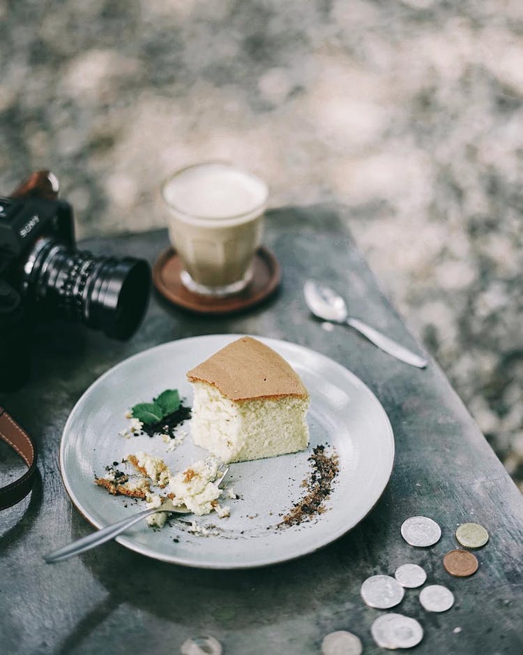 A Slice Of Cake And A Coffee On A Table In A Cafe 