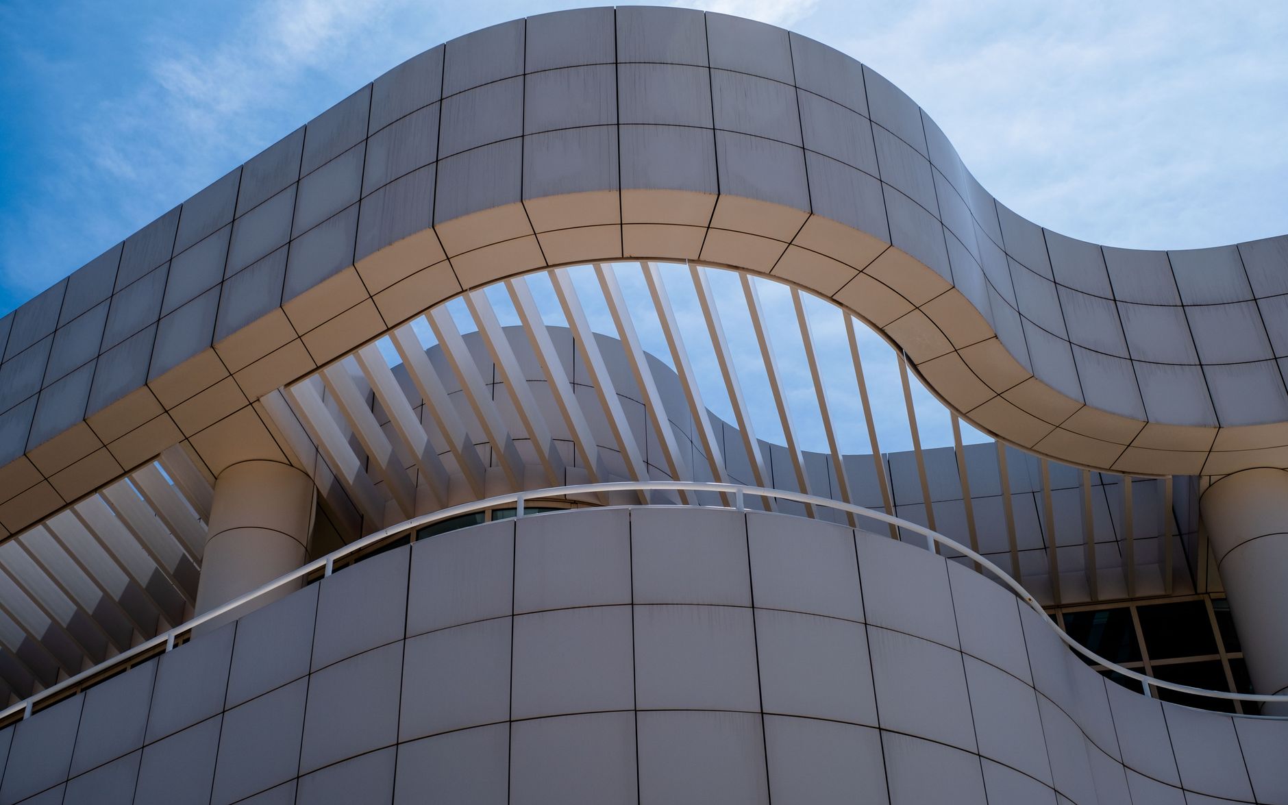 Low angle view of futuristic modern architecture with smooth facade and curves.