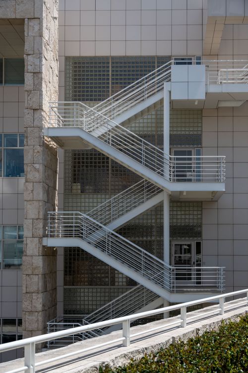 Free Vertical shot of building facade featuring an outdoor emergency exit staircase. Stock Photo