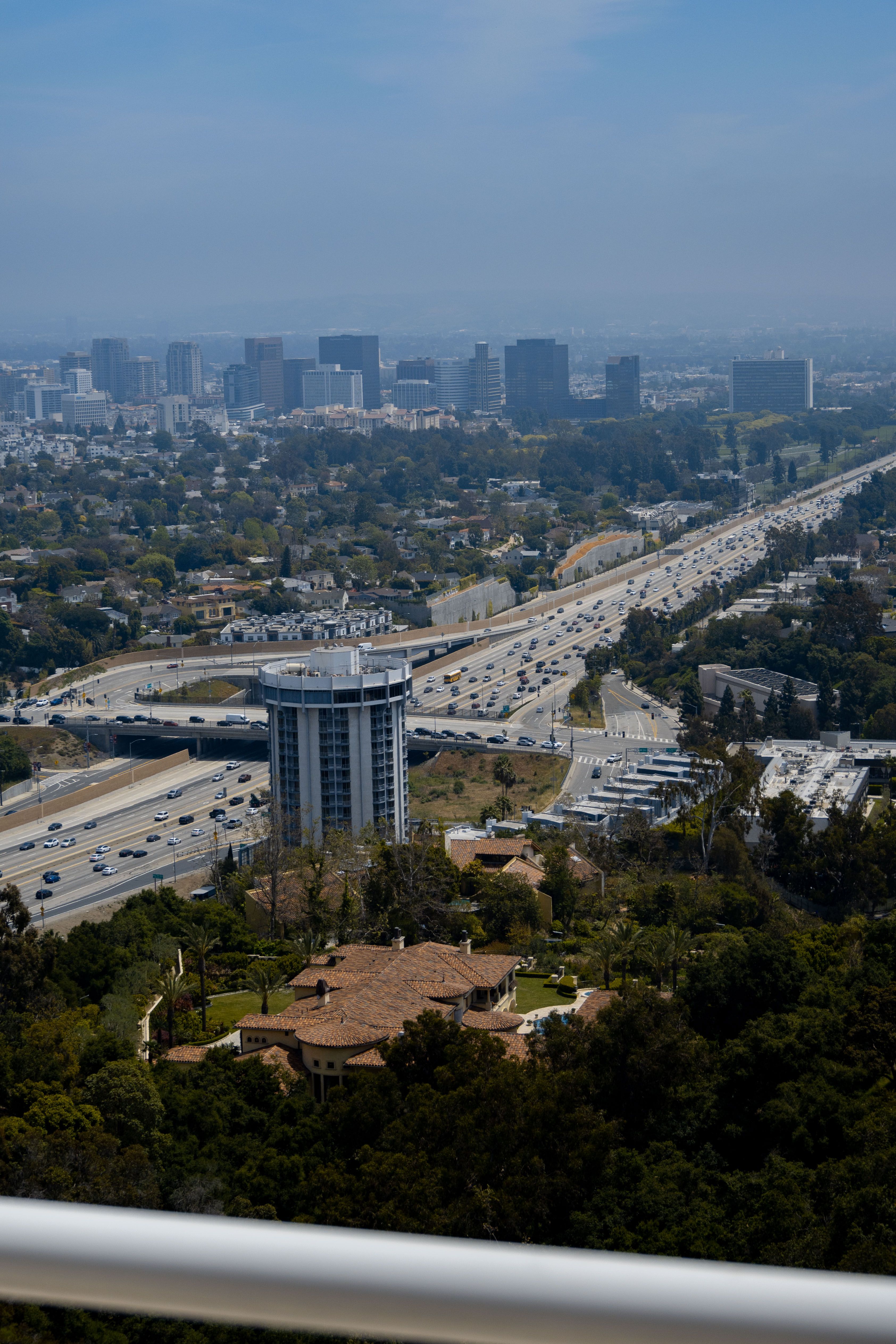 High-angle view of Los Angeles freeway interchanges and the city beyond