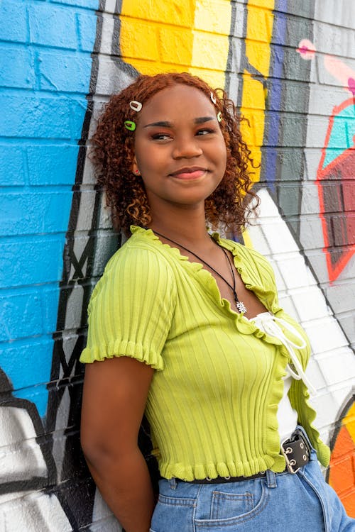 Smiling Woman Posing by Wall with Graffiti
