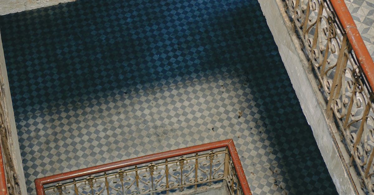 A stairway with a tiled floor and a railing · Free Stock Photo
