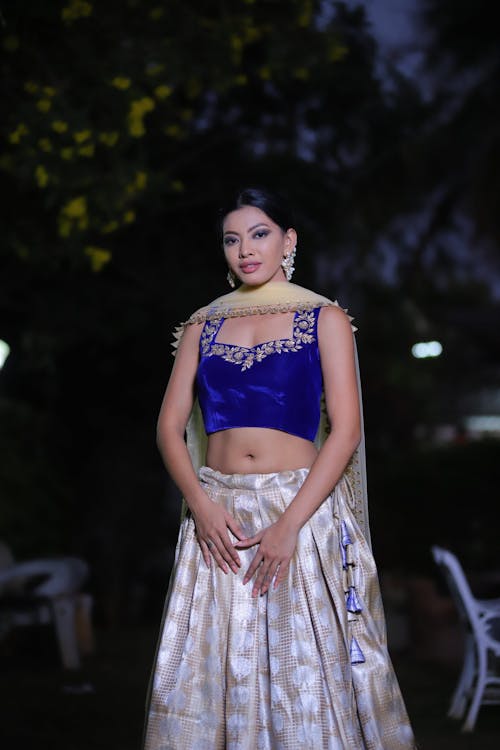 Portrait of a Female Model Wearing a Skirt and a Crop Top Standing Outdoors at Night