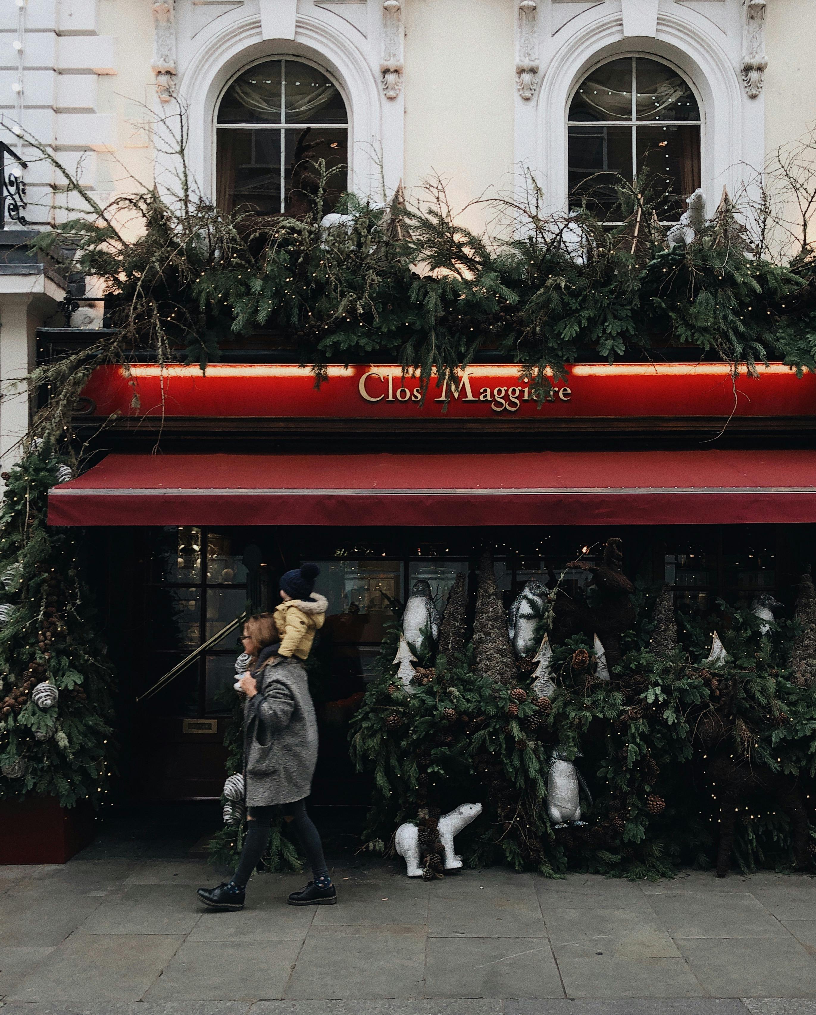 woman carrying child near clos maggiore stall