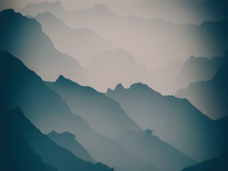 Dramatic mountain silhouettes layered in mist, creating a tranquil and dreamy atmosphere.