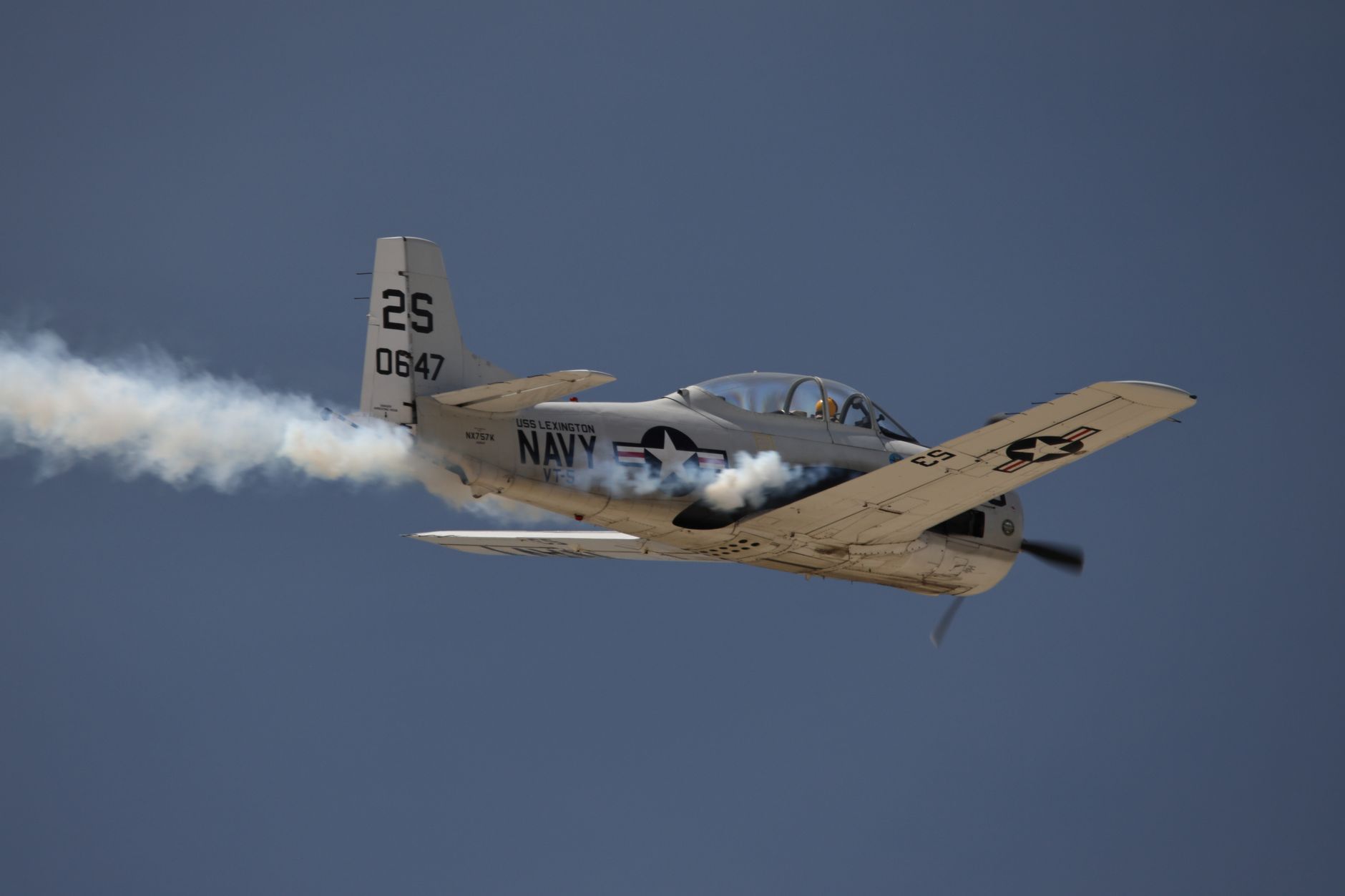 A vintage military aircraft performing aerobatics at March Air Reserve Base airshow.
