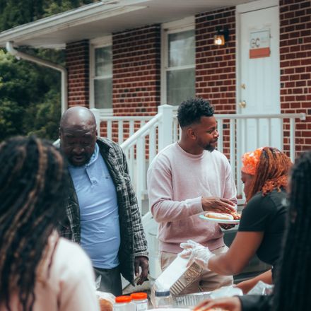 Neighbors serving a community meal, photo by Samuel Peter on Pexels