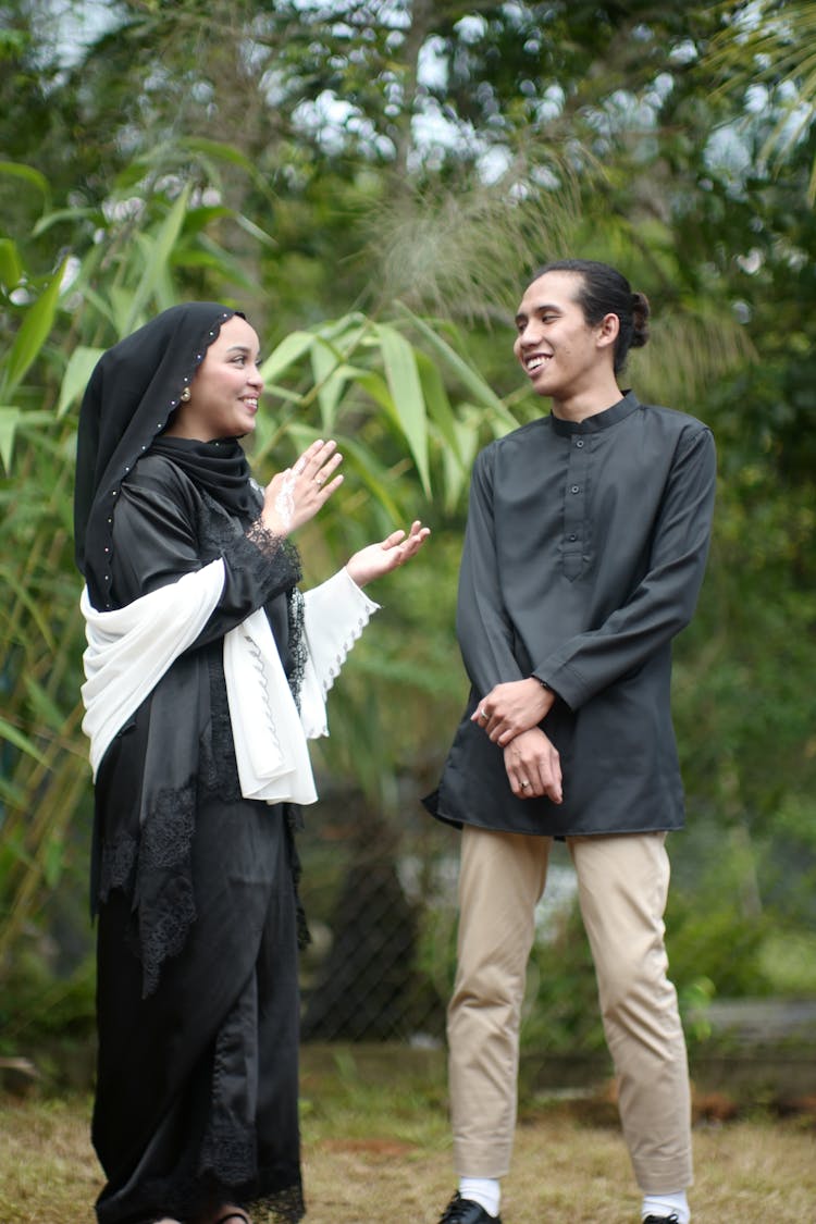 Young Man And Woman In Traditional Clothing Talking And Smiling 