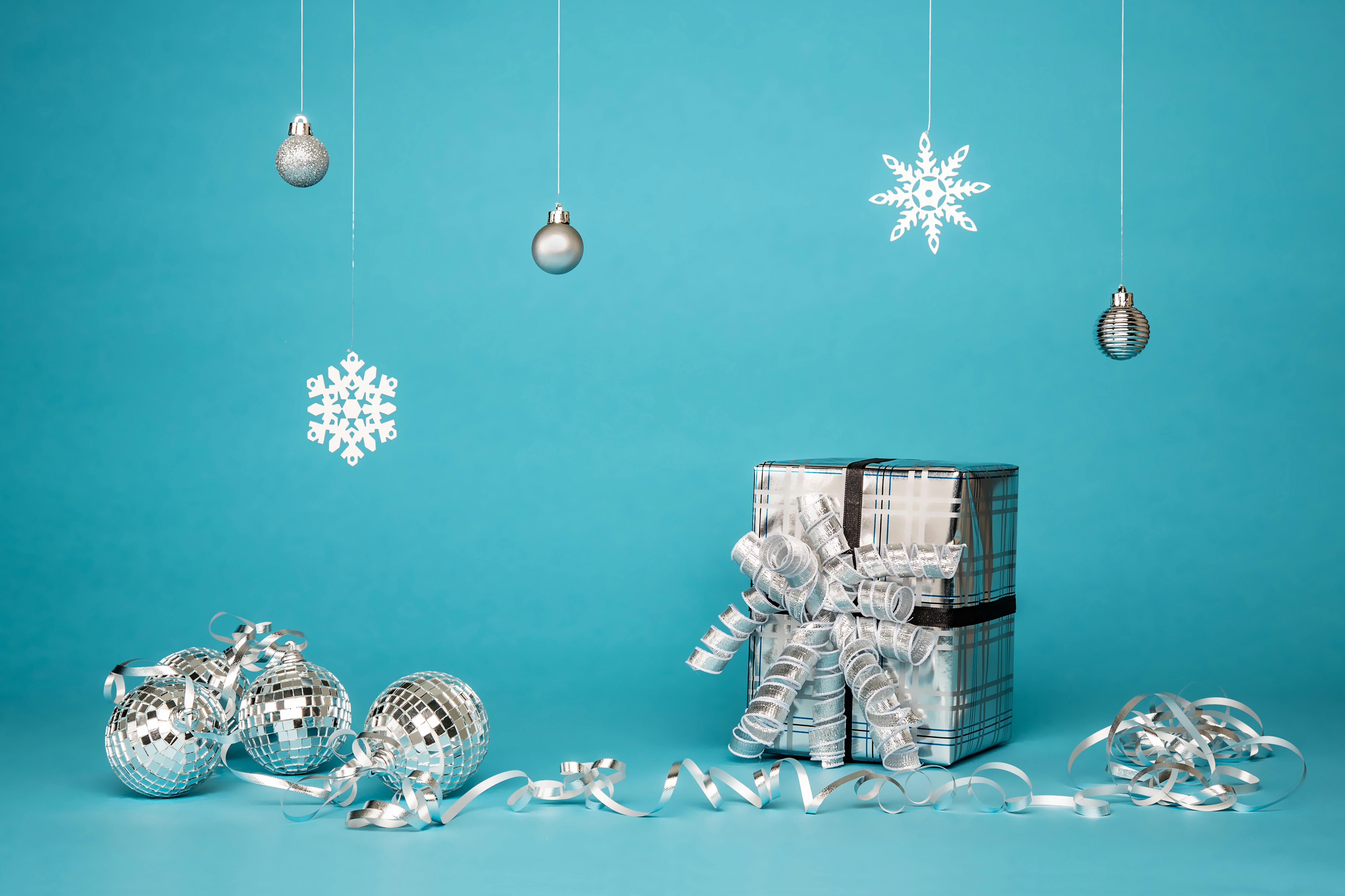 gift box surrounded by grey baubles