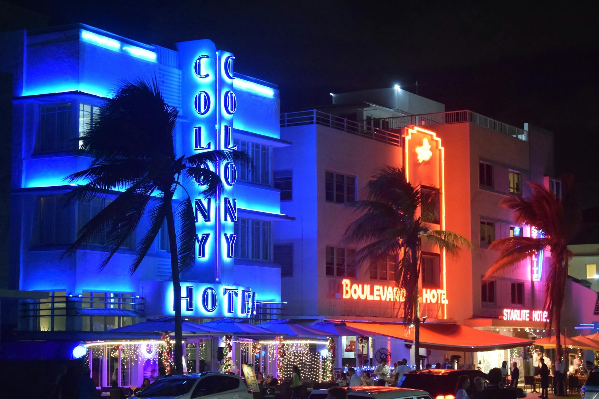 Lively neon-lit hotels illuminate the Miami Beach nightlife, highlighting Art Deco architecture.